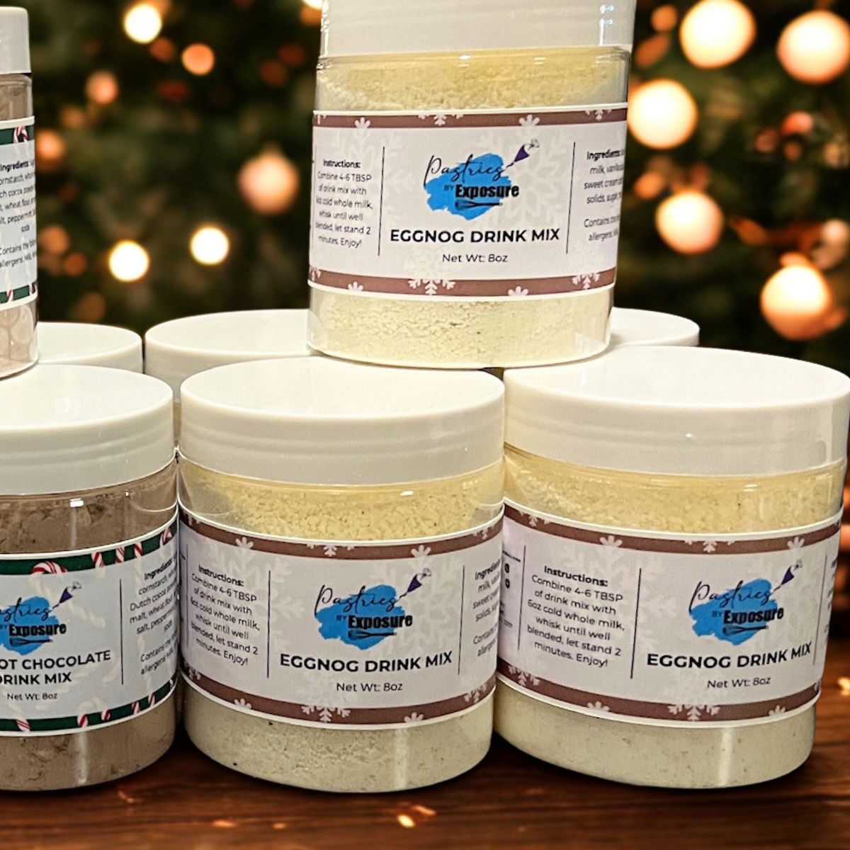 Jars of eggnog drink mix with a blurred Christmas tree in the background