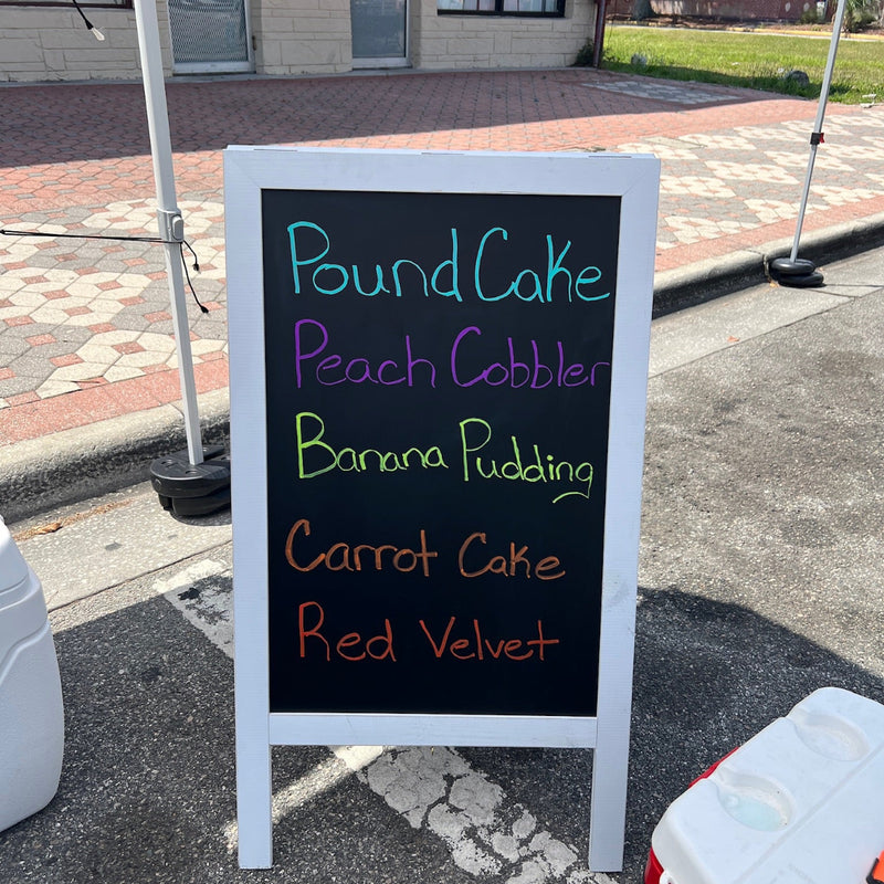 Outdoor sign listing dessert options on a sidewalk