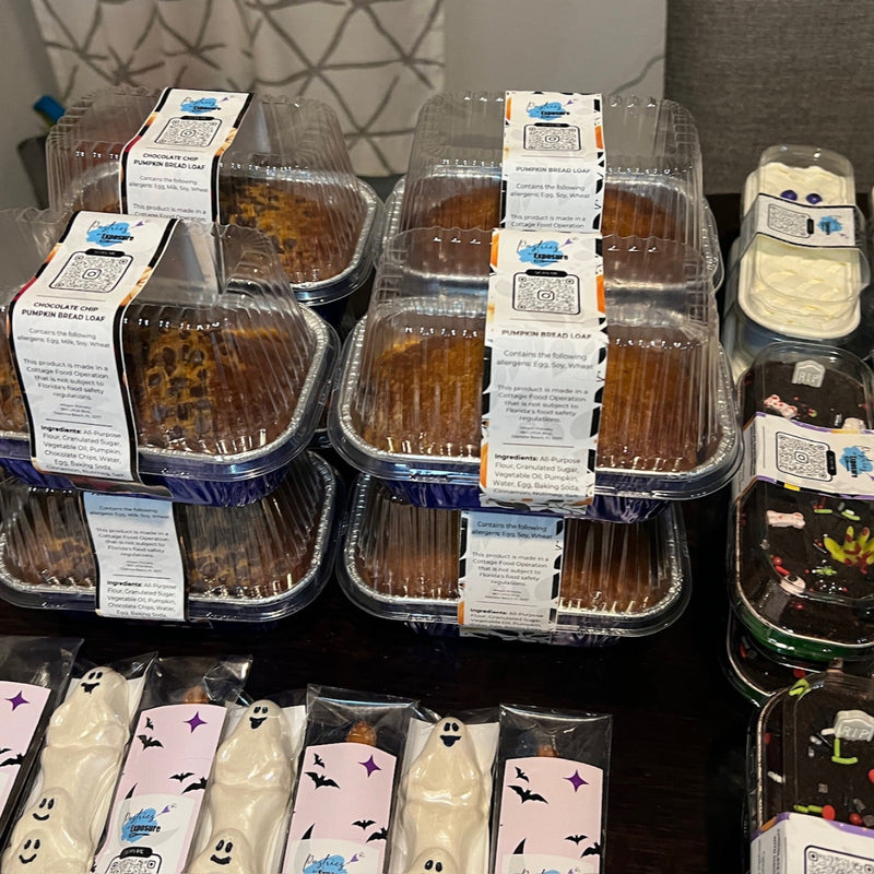 Display of pre-packaged food items on a shelf with a geometric patterned wall in the background.