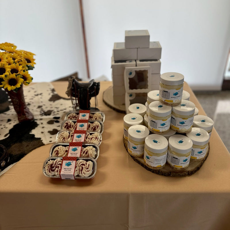 Display of yogurt containers and a small model building on a table.
