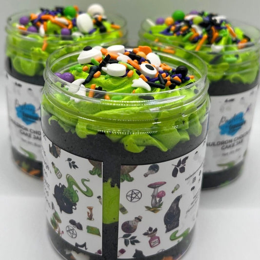 Green dessert in jars with Halloween-themed toppings on a white background